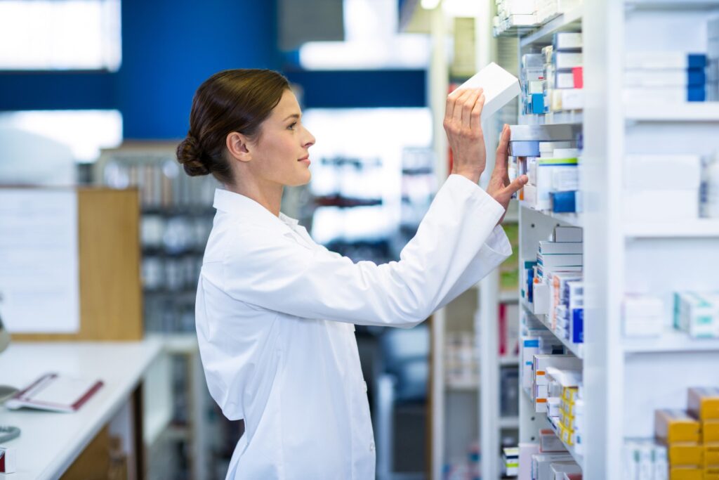 Farmaceutka układająca leki w aptece